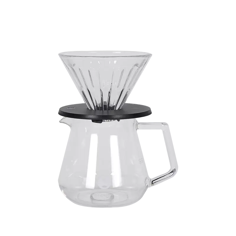 Cafetera pour-over de vidrio transparente con base negra y jarra con asa Timemore
