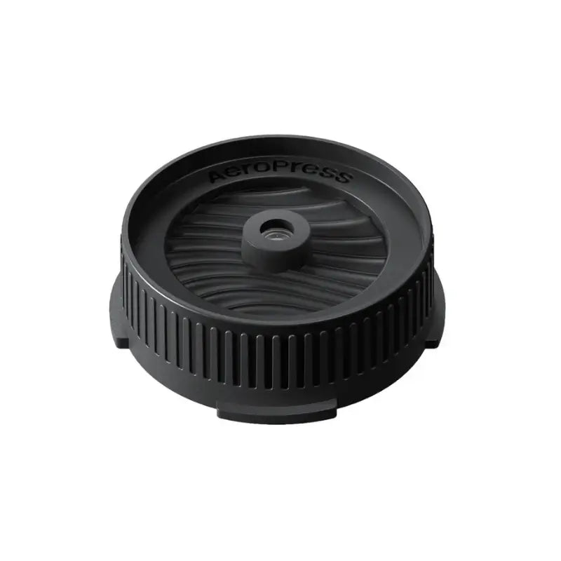 Tapa negra circular para portafiltro Aeropress, con control de flujo