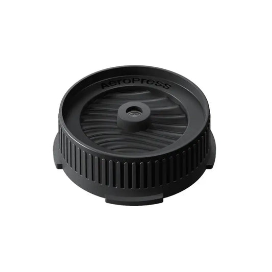 Tapa negra circular para portafiltro Aeropress, con control de flujo