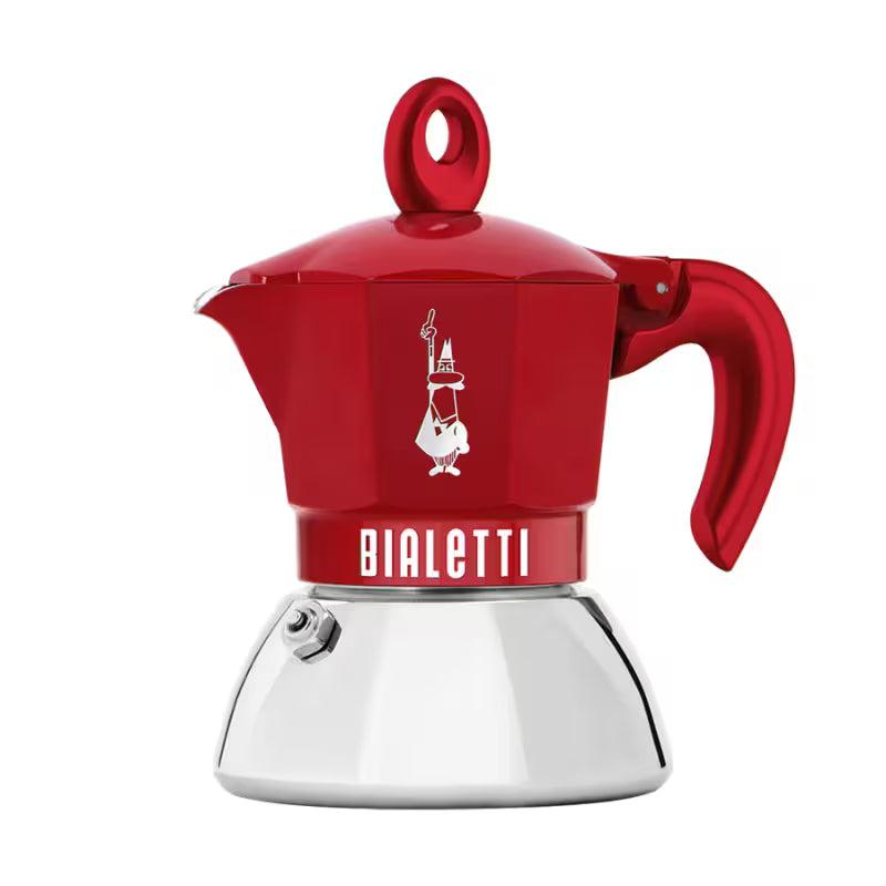 Cafetera moka de Bialetti roja con jarra y asa lateral, base metálica blanca.