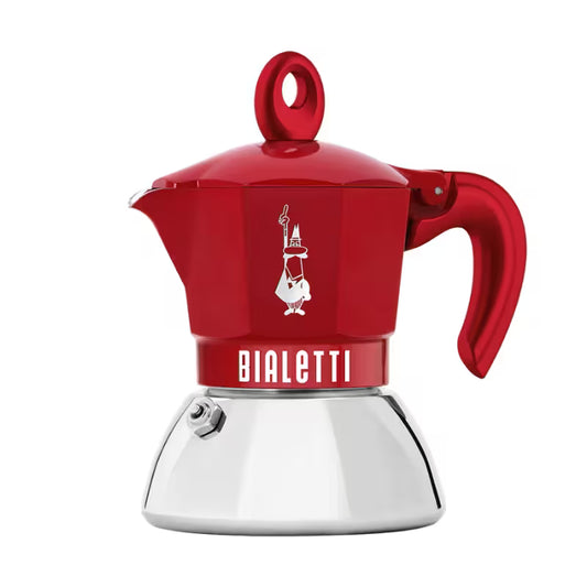 Cafetera moka de Bialetti roja con jarra y asa lateral, base metálica blanca.